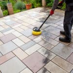 Person worker cleaning the outdoors floor.